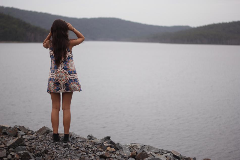 woman on rocky coast near sea