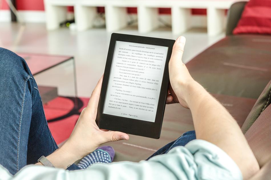 woman reading book on tablet