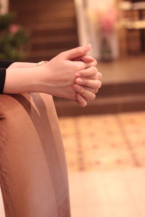 female hands in the lock on the chair