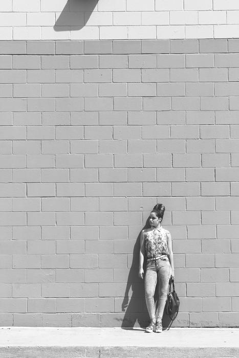 Black and white photo of the woman, with shadow on the wall