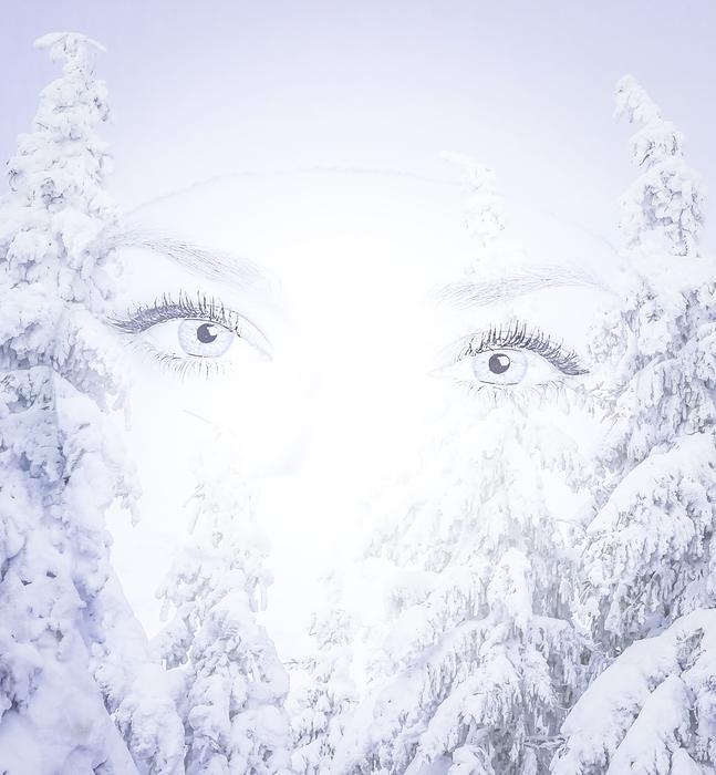 female eyes on the background of trees in the snow