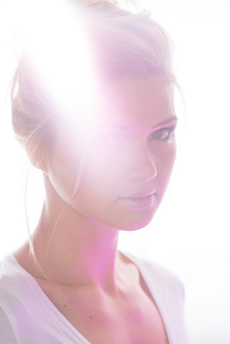 Portrait of the girl in light, at white background
