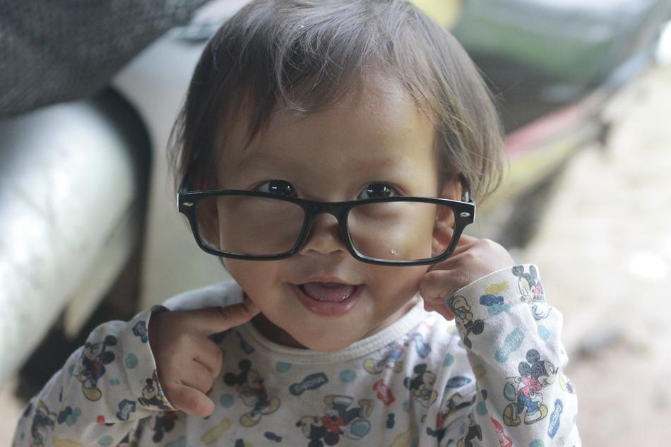 cute baby in women's glasses