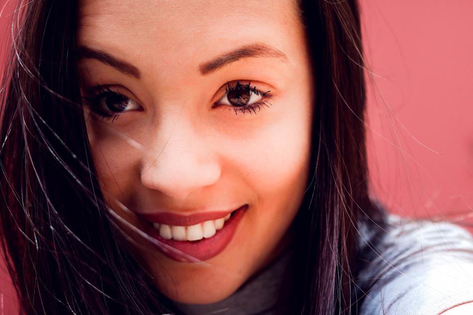 beautiful brunette on a pink background