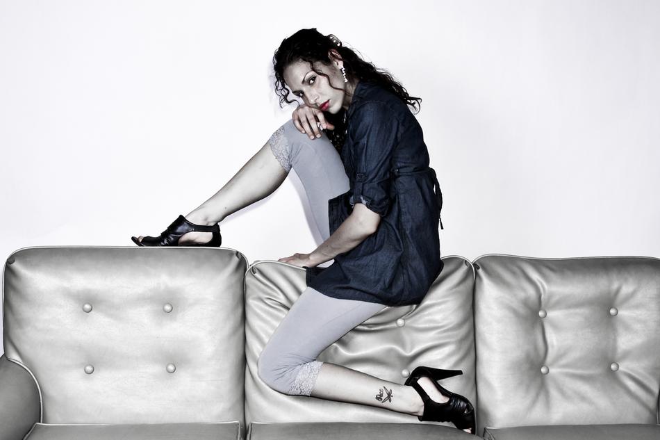 Posing woman with make-up, on the shiny couch