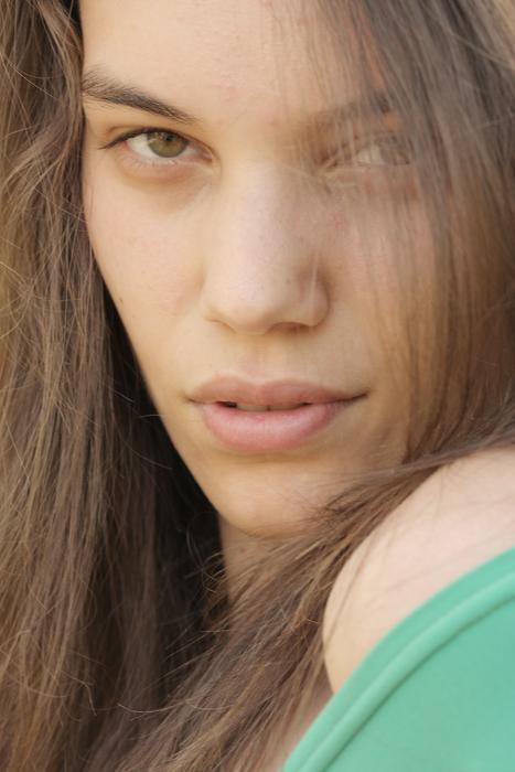 Portrait of a young girl in green clothing