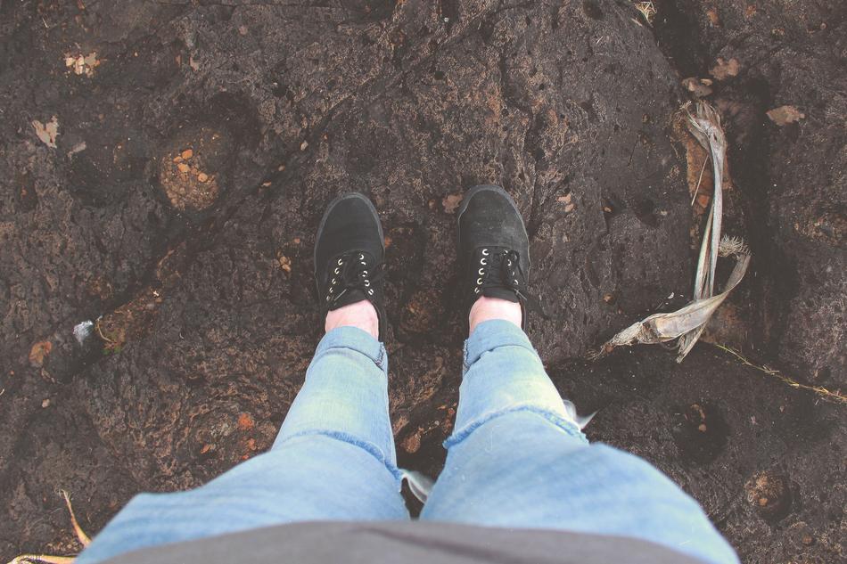 Top view of the legs of the child with black shoes