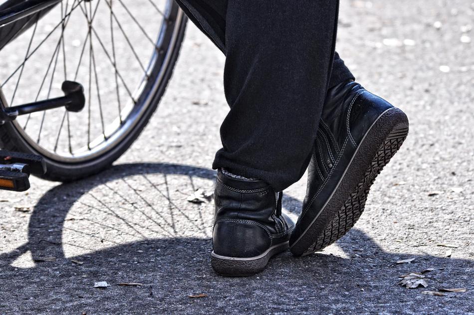 woman's shoe and bicycle wheel