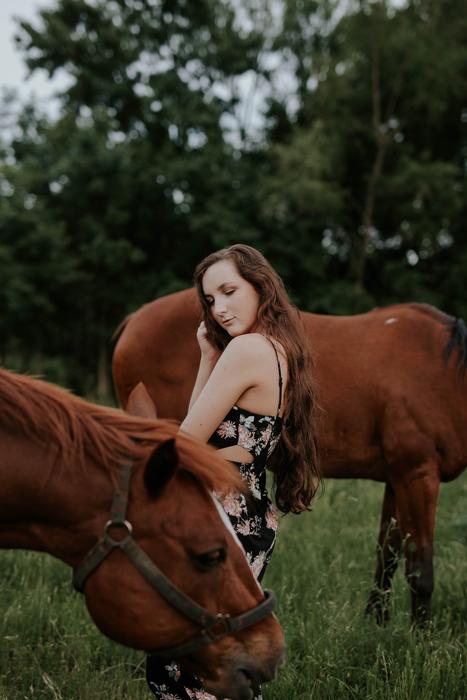 young lady and brown horses