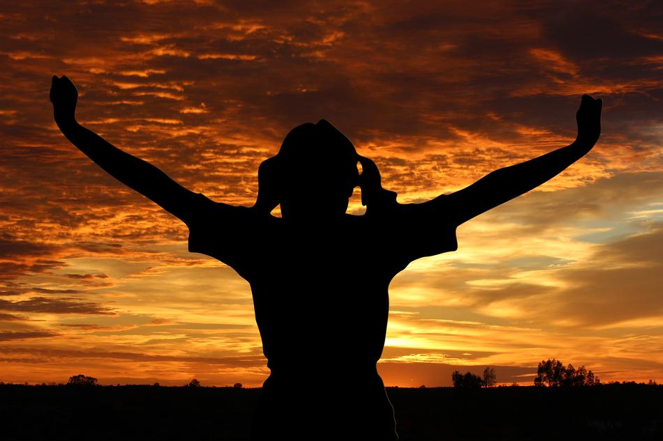 Silhouette of a girl, with the hands up, on the beautiful landscape, at colorful and beautiful sunrise, clipart