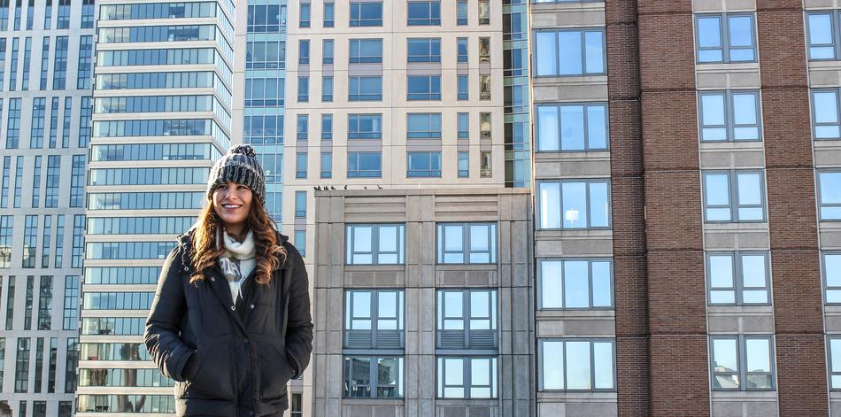 happy young girl in winter clothes at office building