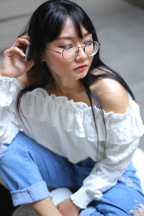 asian woman in round glasses