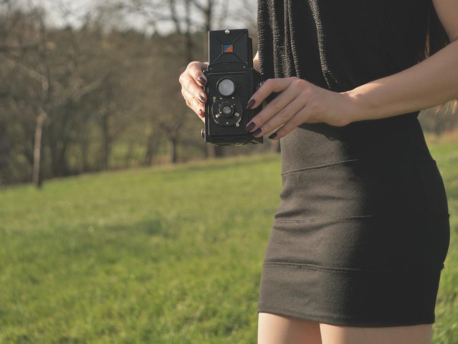 Rollei Camera in female hands outdoor
