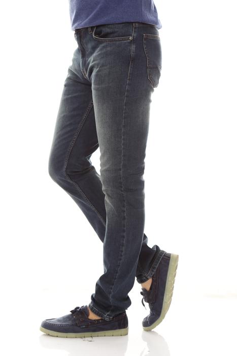 Legs of a male in pants and shoes, at white background