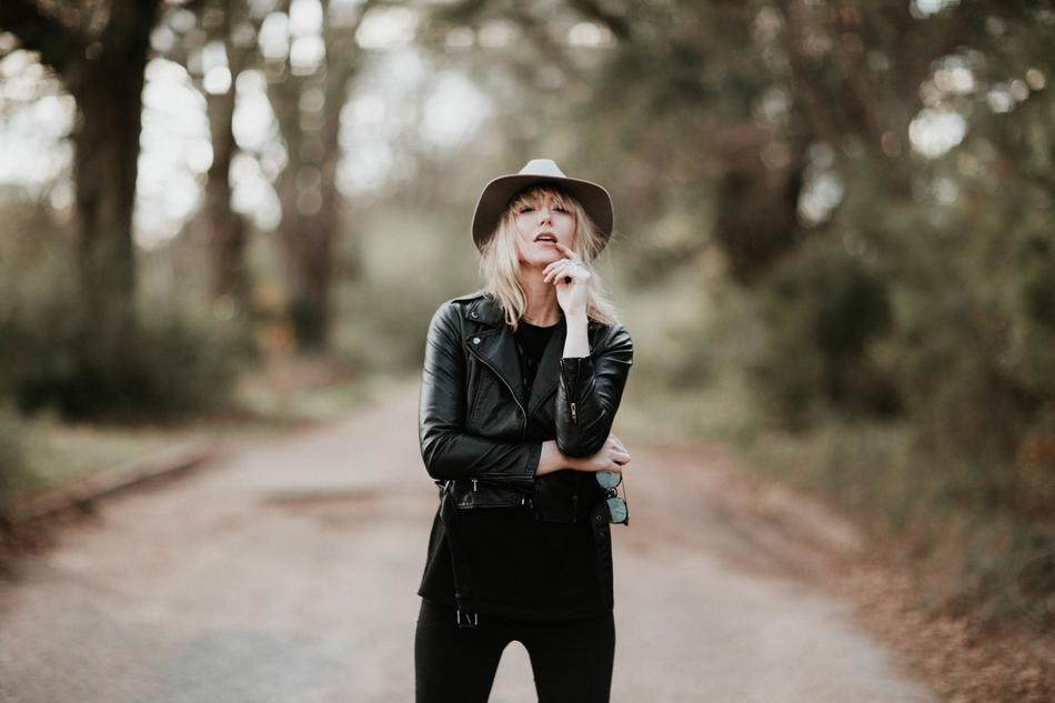 girl in black clothes in the forest on a blurred background