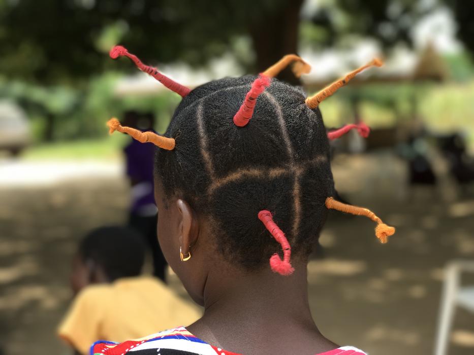 View of the colorful hairstyle with braids, of the African woman in Ghana