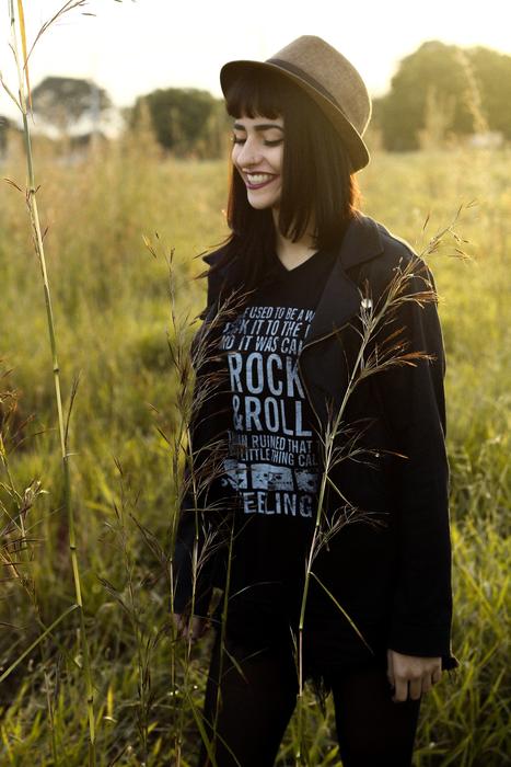 Stylish woman on the landscape with the grass