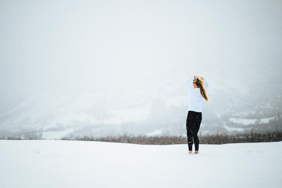 Lady on the snowy road on landscape