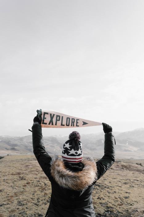 explore, Woman holds banner over head
