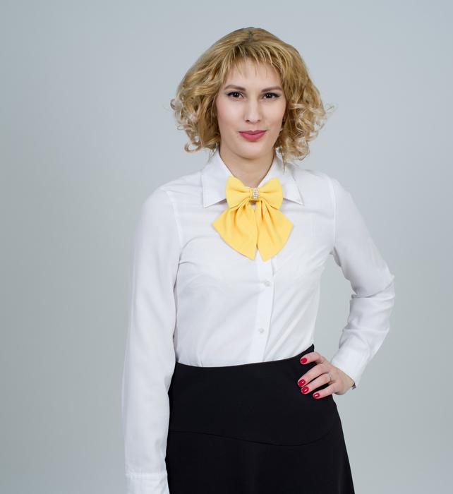 blonde in a white blouse with a yellow bow
