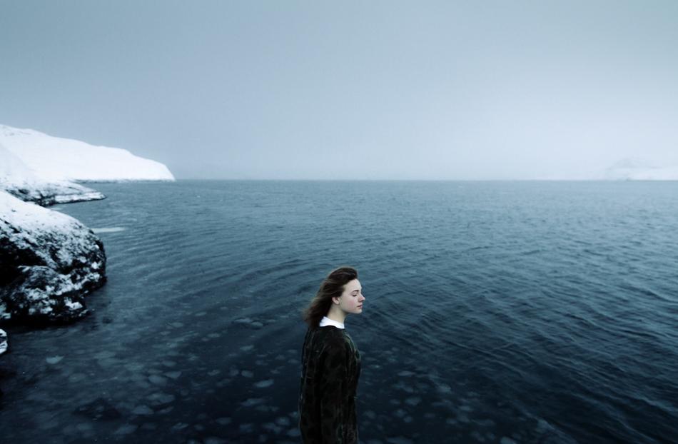 photo of a girl on the background of a cold ocean