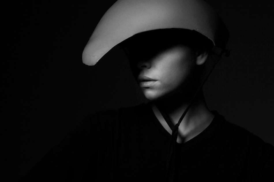 Black and white portrait of the girl in hat, in light and shadow