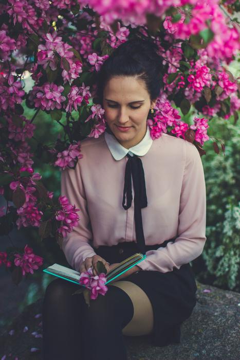Girl with book in garden
