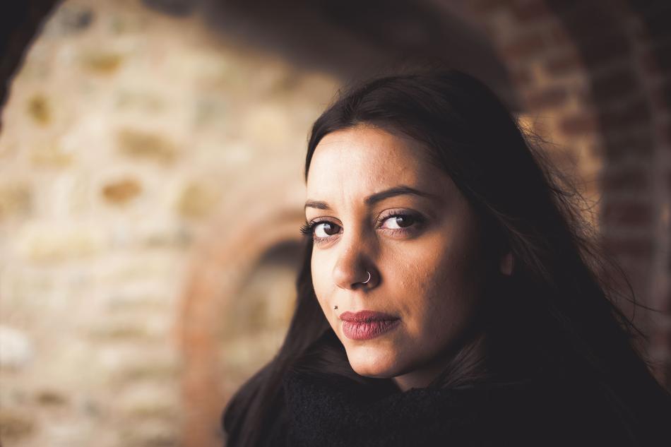 brunette on the background of a brick arch