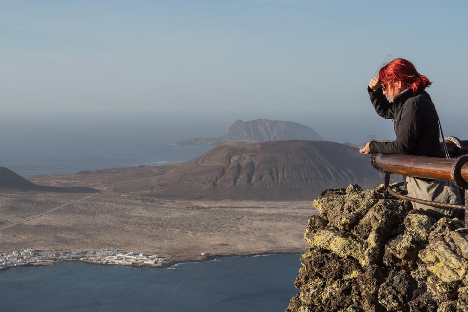 woman with red hair on the edge of the island