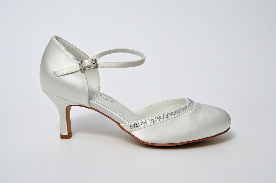 silver dance shoes on white background