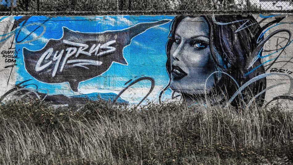 Grey and blue graffiti of different shades, with the woman, in Ayia Napa, Cyprus