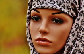 Portrait of the woman mannequin in head cover with leopard pattern