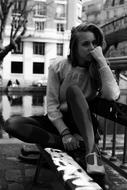 black and white, sad girl on a bench in Paris