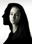 Black and white portrait of the woman with silhouette, at white background