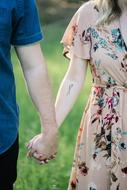couple Holding Hands on meadow