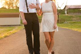 a man in dress pants and a woman in a white dress