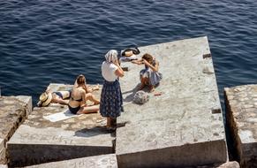 Family on concrete near the sea