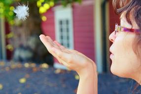 Girl Feather Blowing