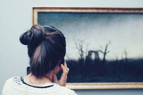 Girl and picture frame in museum