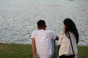 a couple in love sits on the banks of the river in Tashkent