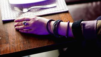 girl's arm wrapped in bracelets