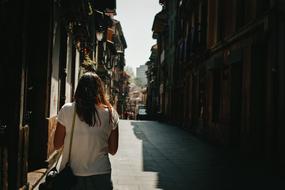 woman walking on alley