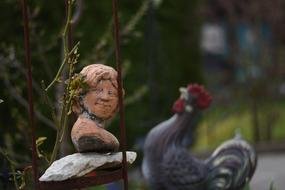 smiling Woman bust and rooster, Garden sculpture