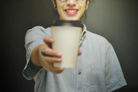 portrait of a woman with paper cup of coffee