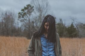 girl with long hair in an autumn field