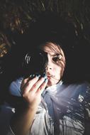 photo of a lying girl with a lens camera