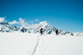 women taking pictures in snowy mountains