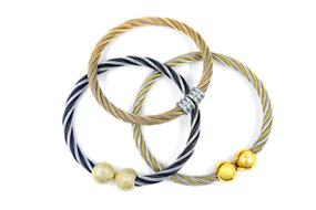 three metal bracelets at white background