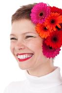 short-haired girl with bright gerberas on her head