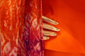 golden female hand beneath red tissue